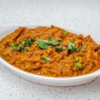 Baigan Bharta · Vegetarian. Clay oven roasted eggplant cooked with green peas and spices in onion and tomato...
