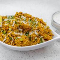 Chicken Biryani · Boneless spicy chicken cooked with basmati rice, onion, bell pepper, and nuts.