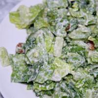 Caesar Salad · Crispy romaine lettuce & garlicky croutons. 
Tossed in our homemade Caesar dressing 
and Par...