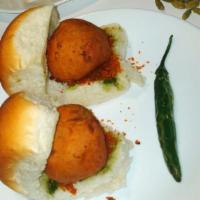 6.Vada Pav (1pc) · Savory slider of fried mashed potato fritters stuffed in a dinner roll with dry garlic chutn...