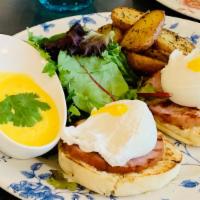 Œufs Benedicte · Canadian bacon, poached eggs, English muffins. Served with mixed greens, roasted potatoes, H...