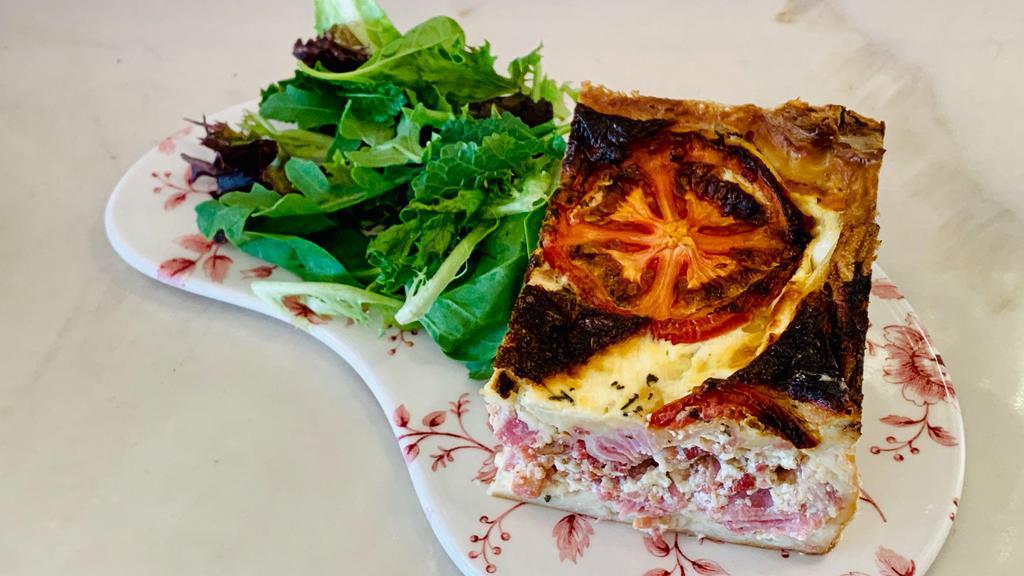 Quiche Lorraine · Ham, bacon, swiss cheese. Served with mixed green salad