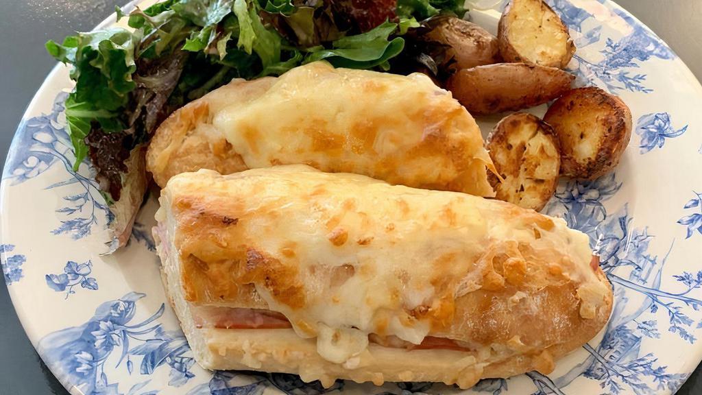 Croque Monsieur · Classic French sandwich with Swiss cheese & béchamel on a baguette. Choice of ham, turkey, or vegetarian (grilled zucchini and tomato). Served with mixed greens and roasted potatoes