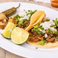 Grande Taco · Two large tortilla , Choice of meat, onion and cilantro.