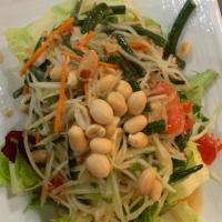 Papaya salad · Shredded green papaya with tomatoes green bean ground peanuts dried shrimps in spicy lime dr...