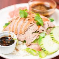 Sp3. Bangkok Roasted Duck · Roasted duck served on a bed of spinach with Thai-style duck sauce over rice.