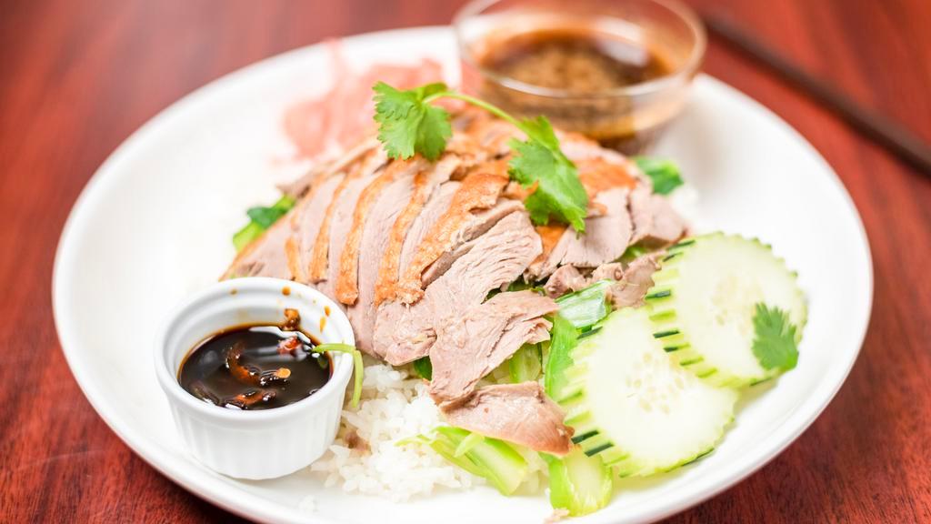 Sp3. Bangkok Roasted Duck · Roasted duck served on a bed of spinach with Thai-style duck sauce over rice.