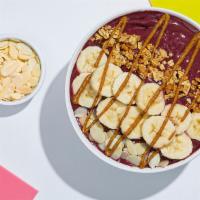 Almond Acai Bowl · Refreshing acai topped with bananas, granola, almond butter, and almonds.