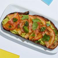 Tomato Avocado Toast · Smashed avocado on whole wheat toast topped with sliced tomato, basil, cracked black pepper,...