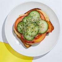 Hummus Toast · Whole wheat toast topped with hummus, refreshing cucumber and tomato slices, and crunchy bea...