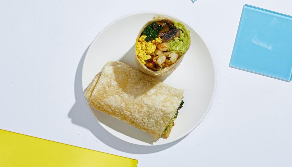 Vegan Breakfast Burrito · Scrambled tofu with seasoned potatoes, spinach, mushrooms, and avocado in a flour tortilla.