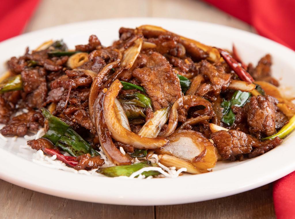 🌶Mongolian · Spicy. Tender beef (or lamb) sauteed with green onion, white onion and red hot pepper in our house sauce served on a crispy rice noodle.