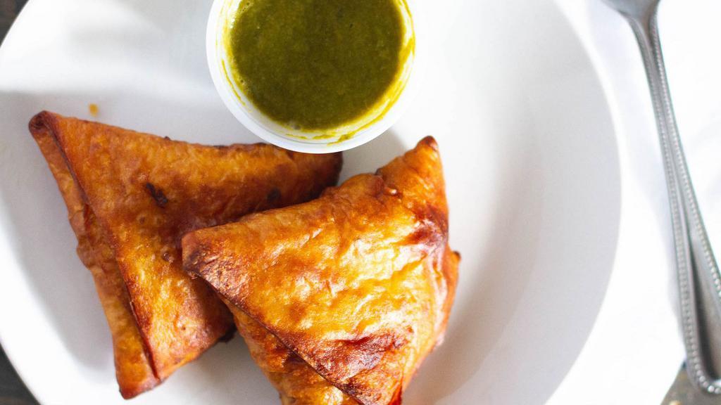 5. Samosa (2 Pc) · Vegan. Deep fried pastry stuffed with mildly spiced potatoes and green peas. Served with homemade mint cilantro sauce and tamarind sauce.