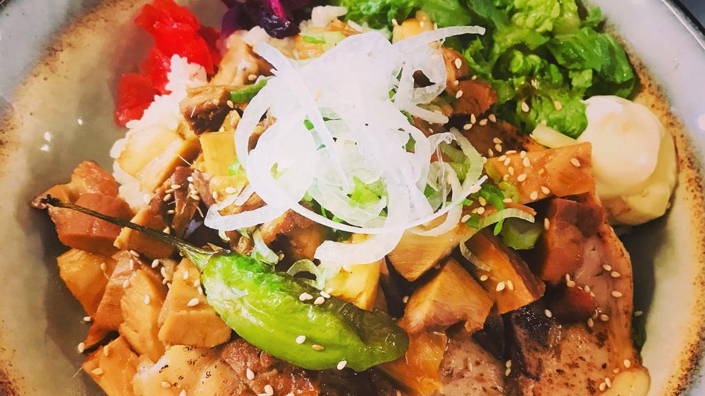 Regular Chashu Don · Soy-based sweet simmered chashu pork over rice, topped with peppers, pickles, onions, fresh greens, sesame seeds & mayo.