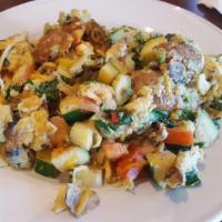 Spinach Scramble · Fresh eggs scrambled with spinach leaves, avocado, mushrooms, potatoes, and cheddar cheese.