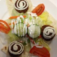 #4. Falafel · Made with fresh vegetables and beans. Served with yogurt sauce, lettuce and lavash bread.