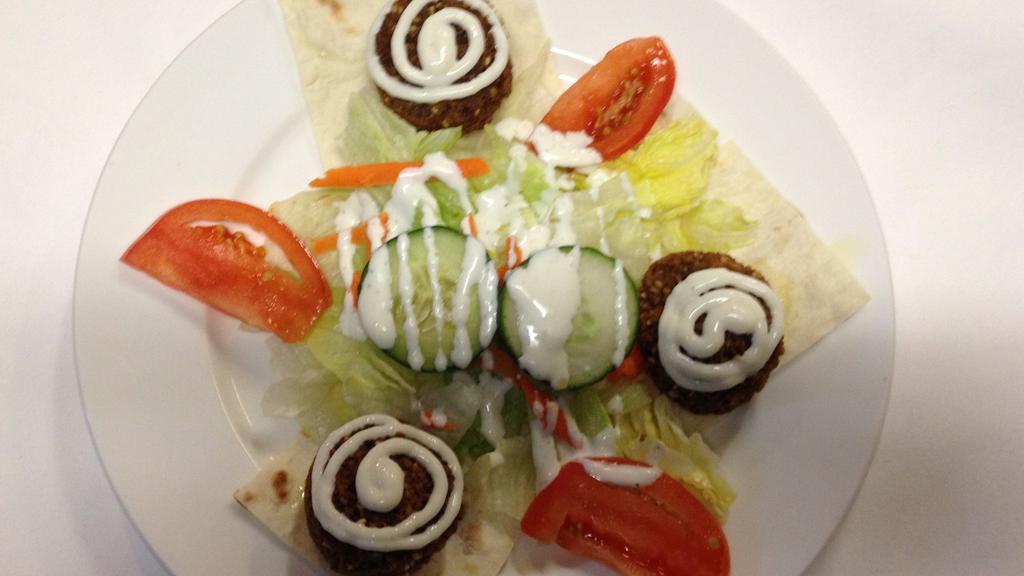 #4. Falafel · Made with fresh vegetables and beans. Served with yogurt sauce, lettuce and lavash bread.