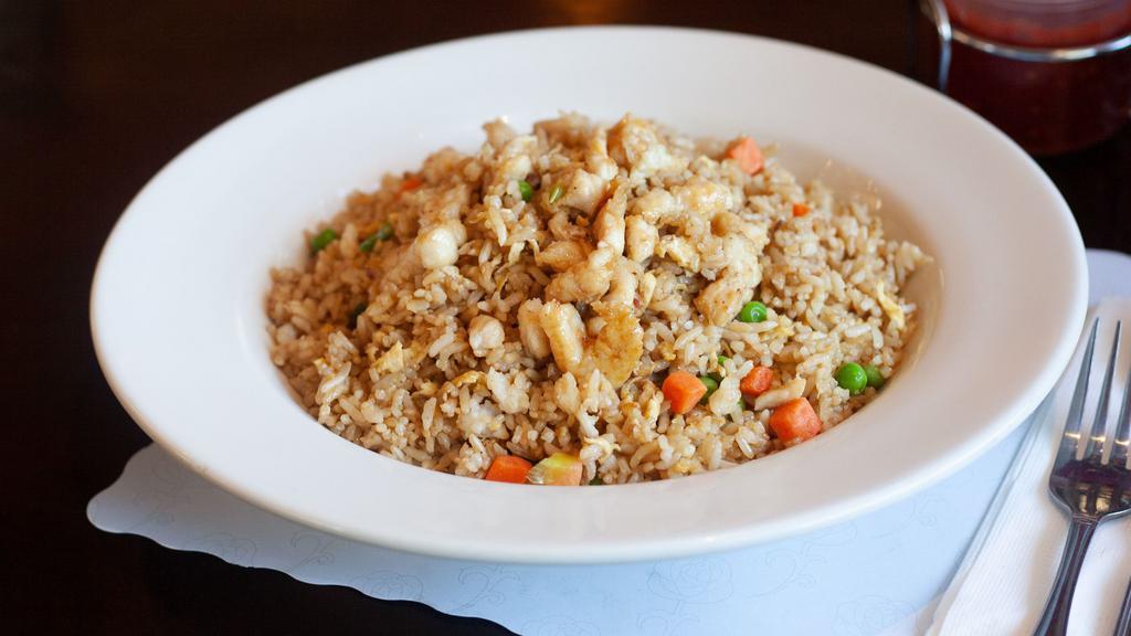 Chicken Fried Rice · Stir fried rice, egg, scallions, peas, and carrots with chicken.