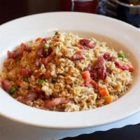 Pork Fried Rice · Stir fried rice, egg, scallions, peas, and carrots with pork.