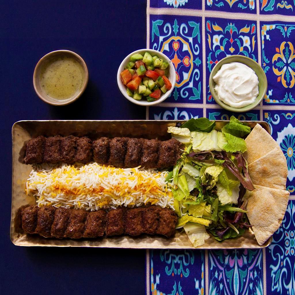 Ground Beef Kabob Rice Platter · Ground beef kabob served with rice, salad, pita bread, and your choice of sauce.