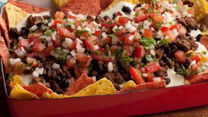 Super Nachos · Crispy corn tortillas chips topped with melted cheese, refried beans, salsa, sour cream, and guacamole.