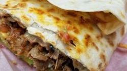 Quesadilla Suiza · Giant flour tortilla filled with cheese, meat, topped with guacamole and sour cream.