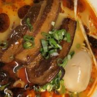 SP4. Spciy Miso Pork Belly Ramen · Spicy. Cooked pork belly, bamboo shoots, bean sprouts, green onion, chicken stock, 1/2 egg.