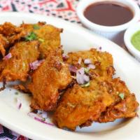 Vegetable Pakora (6 pcs) · Savory vegetable fritters, mildly spiced, dipped in batter.