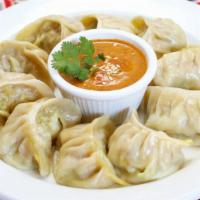 Chicken MoMo (10 pcs) · Traditional Nepali Food. Minced chicken marinated in Nepali spices stuffed in flour wrap and...