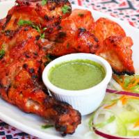 Chicken Tandoori (Leg And Breast) · Chicken(Leg & Breast) Marinated in Yogurt & Red chilli's Spices grilled in clay Oven.