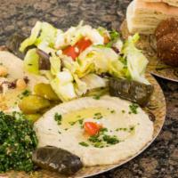 Falafel Veggie Platter · 6 falafel balls, 3 grape leaves, hummus, mutabbal, tabbouleh, house salad, tahini sauce, pic...