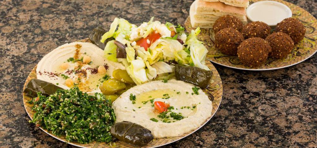Falafel Veggie Platter · 6 falafel balls, 3 grape leaves, hummus, mutabbal, tabbouleh, house salad, tahini sauce, pickles and pita bread.