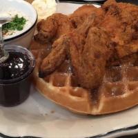 Chicken & Waffles · Sweet and savory southern fried chicken on top of a Belgian waffle.  Served with country gra...