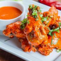 World's Most Delectable Chicken Wings · six crispy chicken wings tossed in your choice of sauce