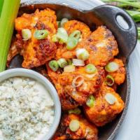 Crispy Buffalo Cauliflower · Roasted cauliflower fried until crispy & tossed in our spicy calabrese wing sauce. Served wi...