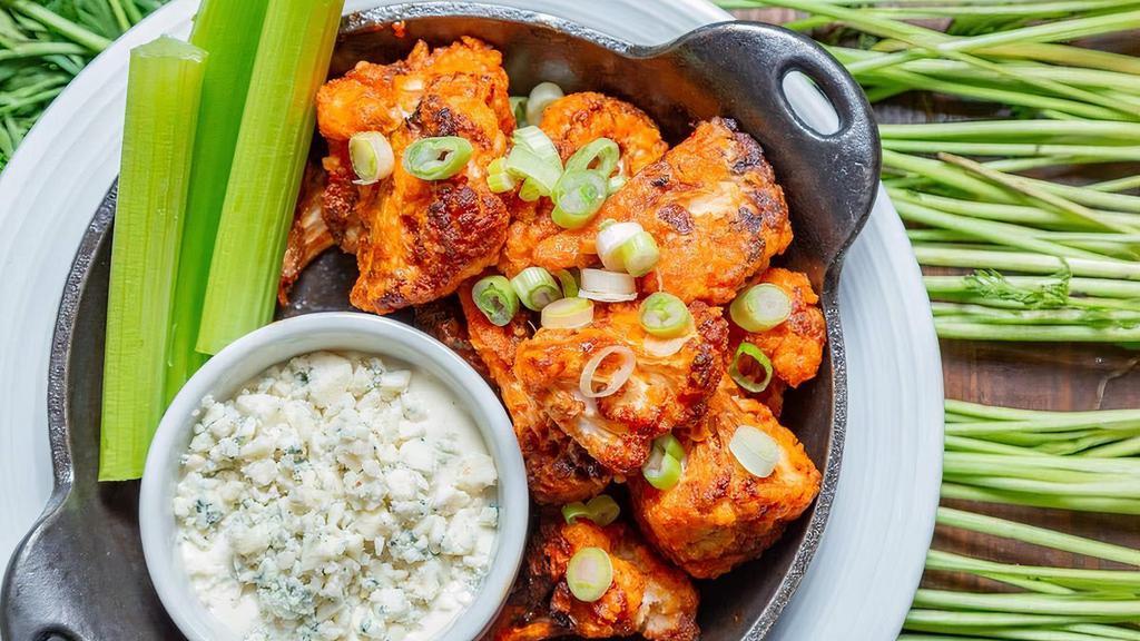 Crispy Buffalo Cauliflower · Roasted cauliflower fried until crispy & tossed in our spicy calabrese wing sauce. Served with celery & blue cheese dressing.