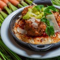 Meatballs & Polenta · Three all-beef, hand-rolled meatballs served on a bed of three-cheese polenta and bolognese ...