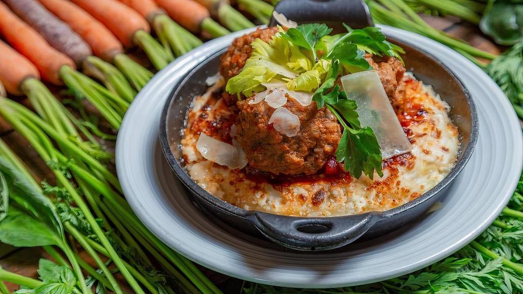 Meatballs & Polenta · Three all-beef, hand-rolled meatballs served on a bed of three-cheese polenta and bolognese sauce.