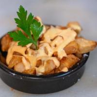 Patatas Bravas · Crispy fried potato cubes with brava & ali oli sauce. Vegetarian.