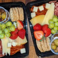 Mini Meat & Cheese · Medley of artisan spanish cheeses, chorizos, olives, fruit and crackers.