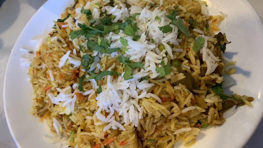 Veggie Biryani · Basmati rice with mixed vegetable, herbs and spices.