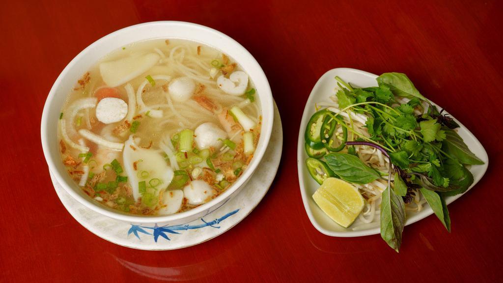 #22 Hu Tieu My Tho - Seafood Pho · Seafood noodle soup (fresh chicken stock) w/calamari, fish balls, shrimp, & Imitation crab, served w/beansprouts, basil, cilantro, jalapeno, lime, & hoisin sauce mixed w/dash of sriracha sauce.