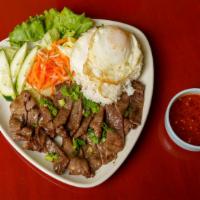 #56 Charbroiled Sliced Beef · Charbroiled marinated sliced beef served over steamed rice & side of sweet vinegar sauce (ga...
