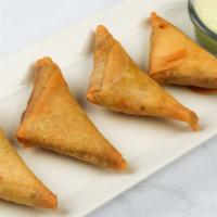 Chicken Samosas · Crispy Wrappers Filled with Spiced Chicken. Served with Cilantro Dipping Sauce