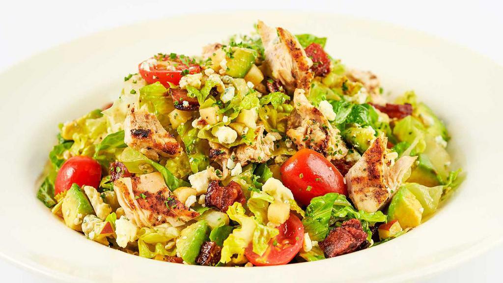 Skinnylicious® Factory Chopped Salad · A Delicious Blend of Julienne Romaine, Grilled Chicken, Tomato, Avocado, Corn, Bacon, Blue Cheese and Apple with Our SkinnyLicious® Vinaigrette