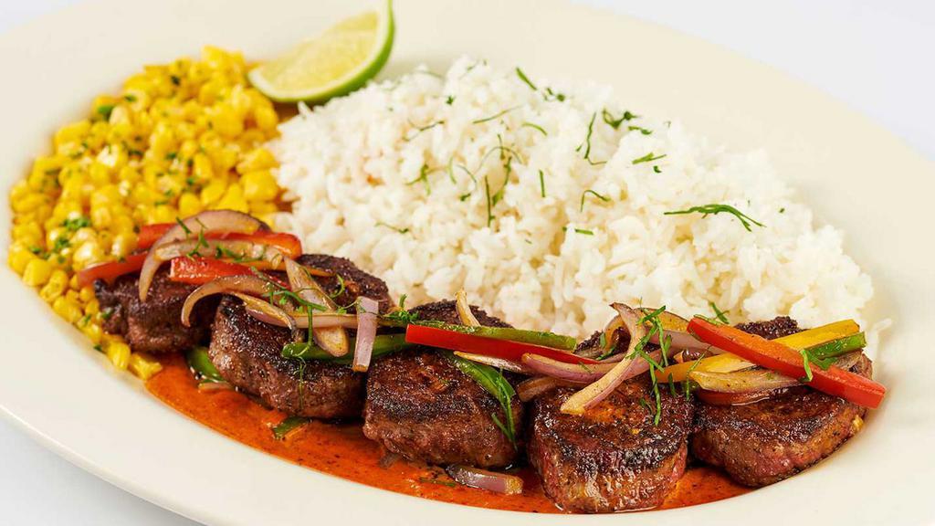 Carne Asada Steak · Steak Medallions Covered with Sauteed Peppers, Onions and Cilantro.  Served with Creamy Ranchero Sauce, Fresh Corn and White Rice