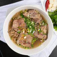 Hủ Tiếu Xương Nước · Rice noodle with pork bone and soup.
