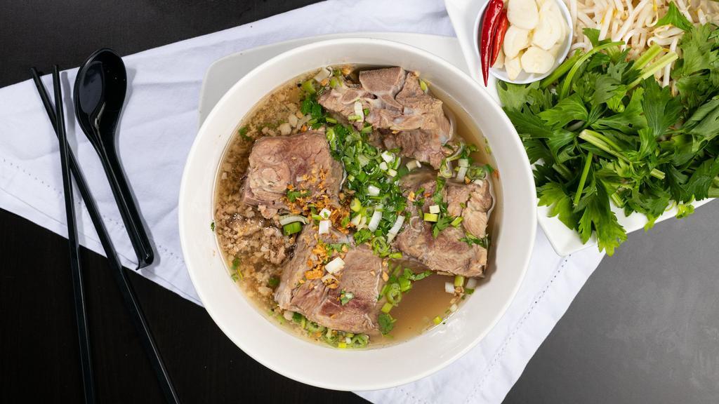 Hủ Tiếu Xương Nước · Rice noodle with pork bone and soup.