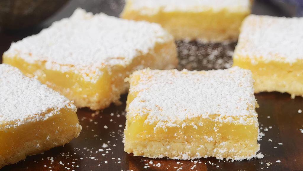 Lemon Bar · A beloved classic treat! Buttery shortbread crust, tangy lemon filling, and a dusting of powdered sugar on top. So bright, citrus-y, & happy!