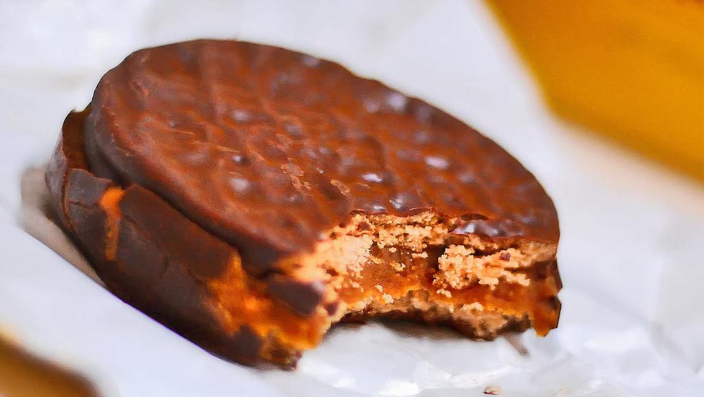 Chocolate Alfajor · Chocolate cookies joined with dulce de leche and covered in dark Guittard chocolate. All of our chocolate is made in an Oompa-Loompa free facility